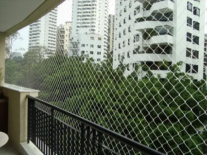 balcony safety netting installed on high-rise apartment railing - transparent mesh prevents pet/child falls while maintaining urban views