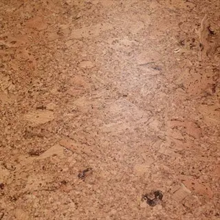 close-up of a natural cork flat surface with textured grain patterns and warm brown tones