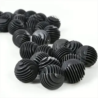 collection of black aquarium bio balls with porous ribbed texture for biological filtration in fish tanks, arranged on white background