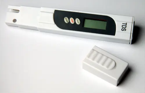 digital aquarium tester (tds meter) with lcd display, control buttons, and protective cap on white background