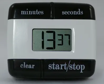 digital kitchen timer with black buttons labeled 'minutes', 'seconds', 'clear' and 'start/stop', displaying 13 minutes and 37 seconds on white lcd screen