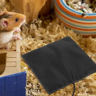 hamster heating pad setup: syrian hamster in bedding observing black temperature-controlled heating pad in cage with striped food bowl