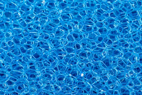 macro view of blue aquarium coarse filter sponge with porous honeycomb structure for mechanical filtration in fish tanks