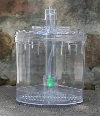 transparent aquarium canister filter with green flow control valve and intake tube for mechanical/biological filtration in fish tanks