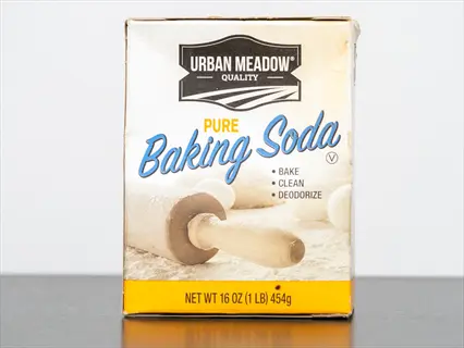 urban meadow baking soda box featuring text 'pure baking soda', usage icons ('bake', 'clean', 'deodorize'), and a rolling pin graphic on a table surface