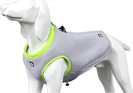 white dog mannequin wearing a gray mesh dog cooling harness insert with neon green trim and reflective details